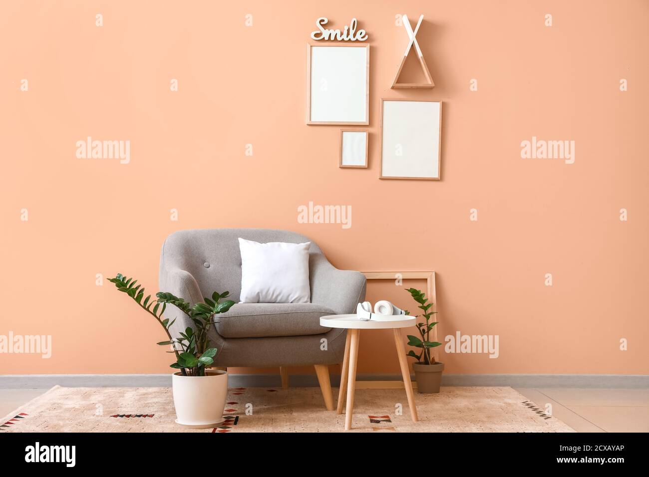 Interior of modern room with armchair and table Stock Photo - Alamy
