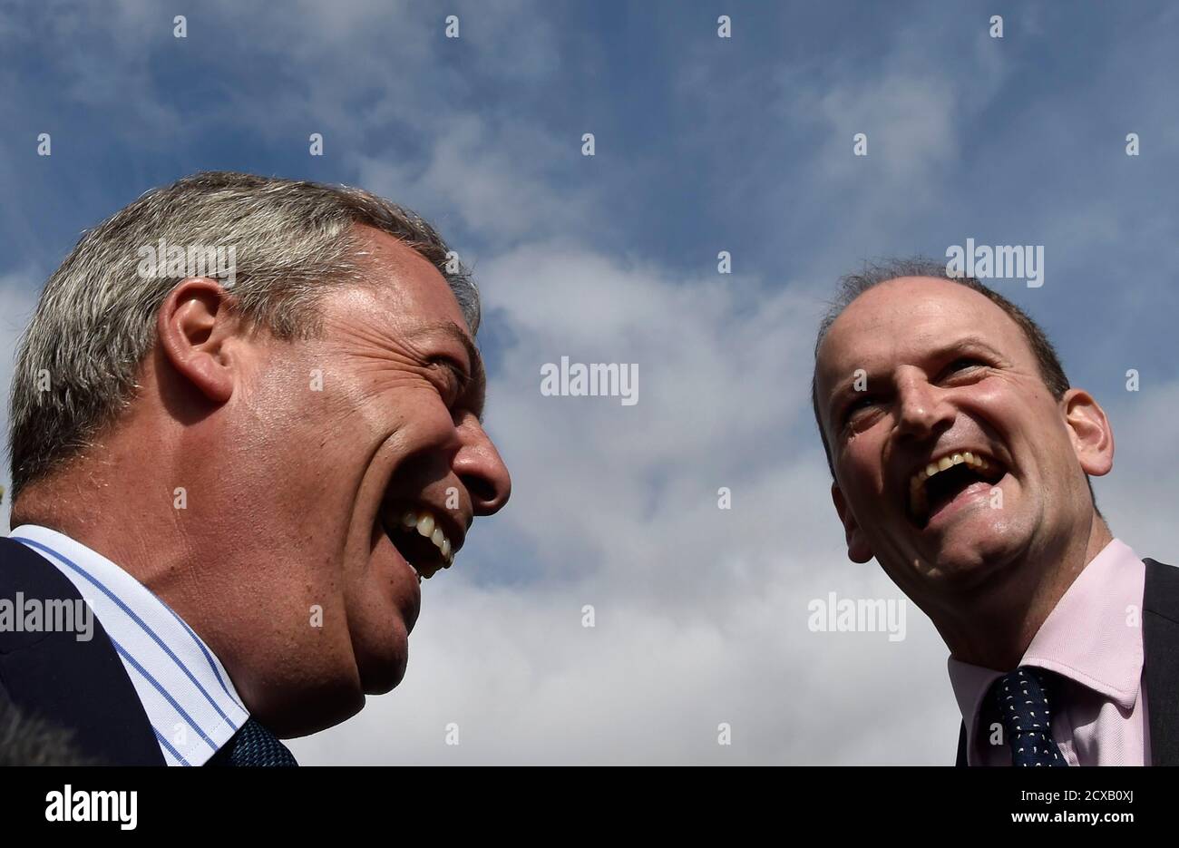 Member of Parliament (MP) Douglas Carswell (R) and Nigel Farage, the leader of Britain's UK Independence Party (UKIP) party, laugh as they walk through the town centre of Clacton-on-Sea in south east England August 29, 2014. British Prime Minister David Cameron suffered a setback on Thursday when a lawmaker from his ruling Conservative party unexpectedly resigned and defected to the anti-EU UKIP party which has no seats in the British parliament. The defection of Douglas Carswell comes eight months before a national election in which UKIP threatens Cameron's re-election chances.   REUTERS/Toby Stock Photo