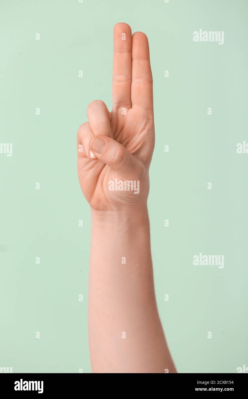 Hand showing letter U on color background. Sign language alphabet Stock ...