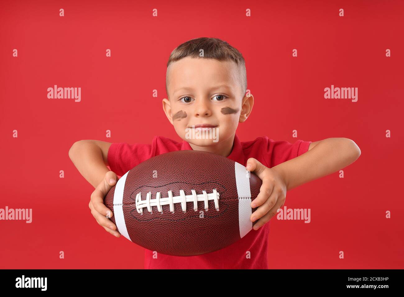 Little boy with rugby ball on color background Stock Photo Alamy