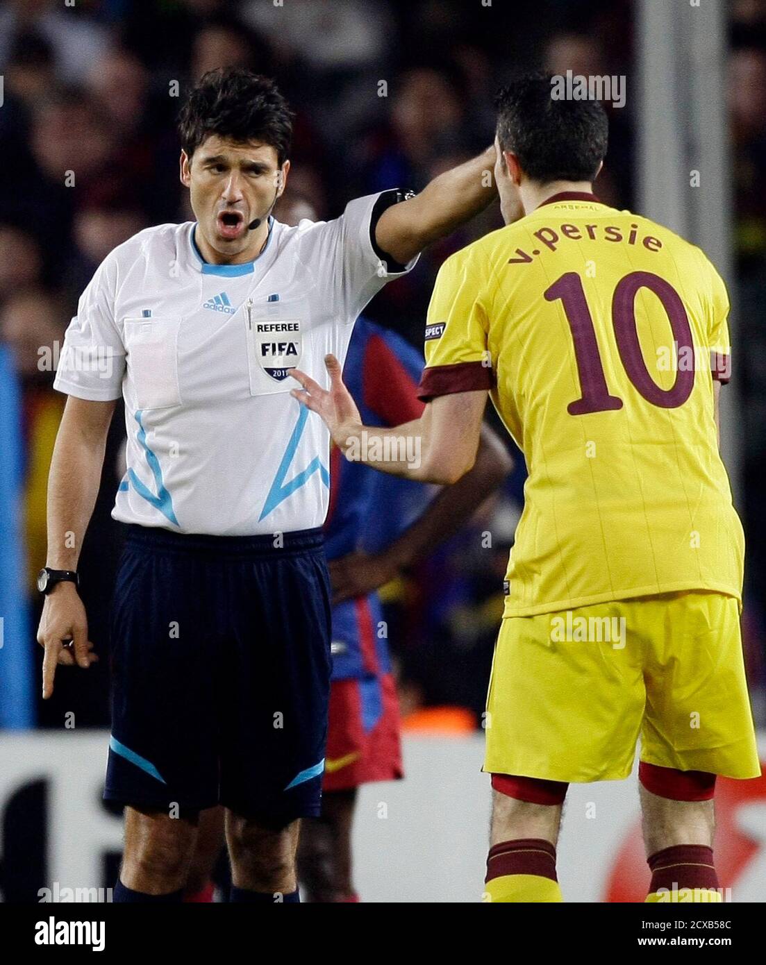 Arsenal's Robin van Persie (10) reacts to Swiss referee Massimo Busacca  after receiving a red card during their Champions League soccer match  against Barcelona at Nou Camp stadium in Barcelona March 8,