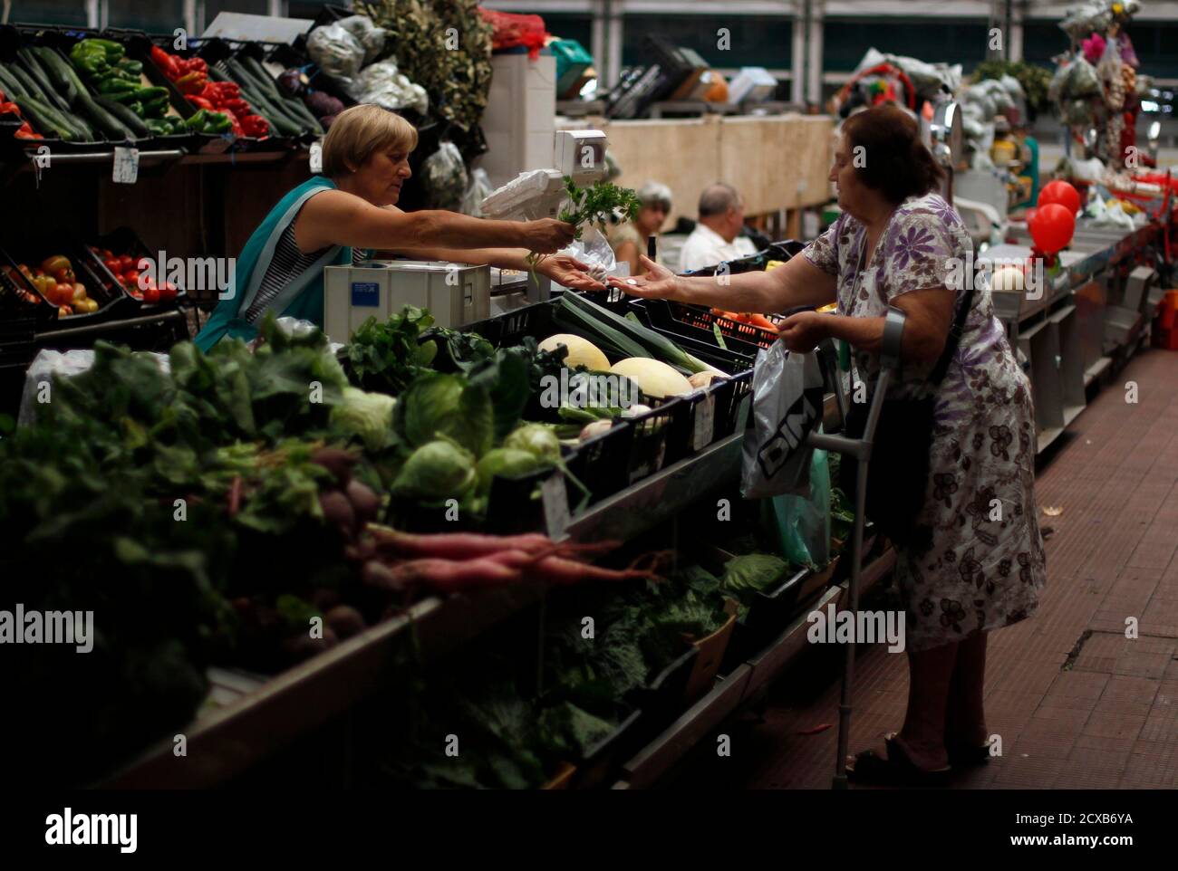 A woman buys parsley at the Ribeira market in Lisbon August 30 , 2011. The economic climate indicator for Portugal again worsened in August 2011, reaching the lowest level since May 2009, announced the National Statistics Institute. REUTERS/Rafael Marchante (PORTUGAL - Tags: SOCIETY BUSINESS) Stock Photo