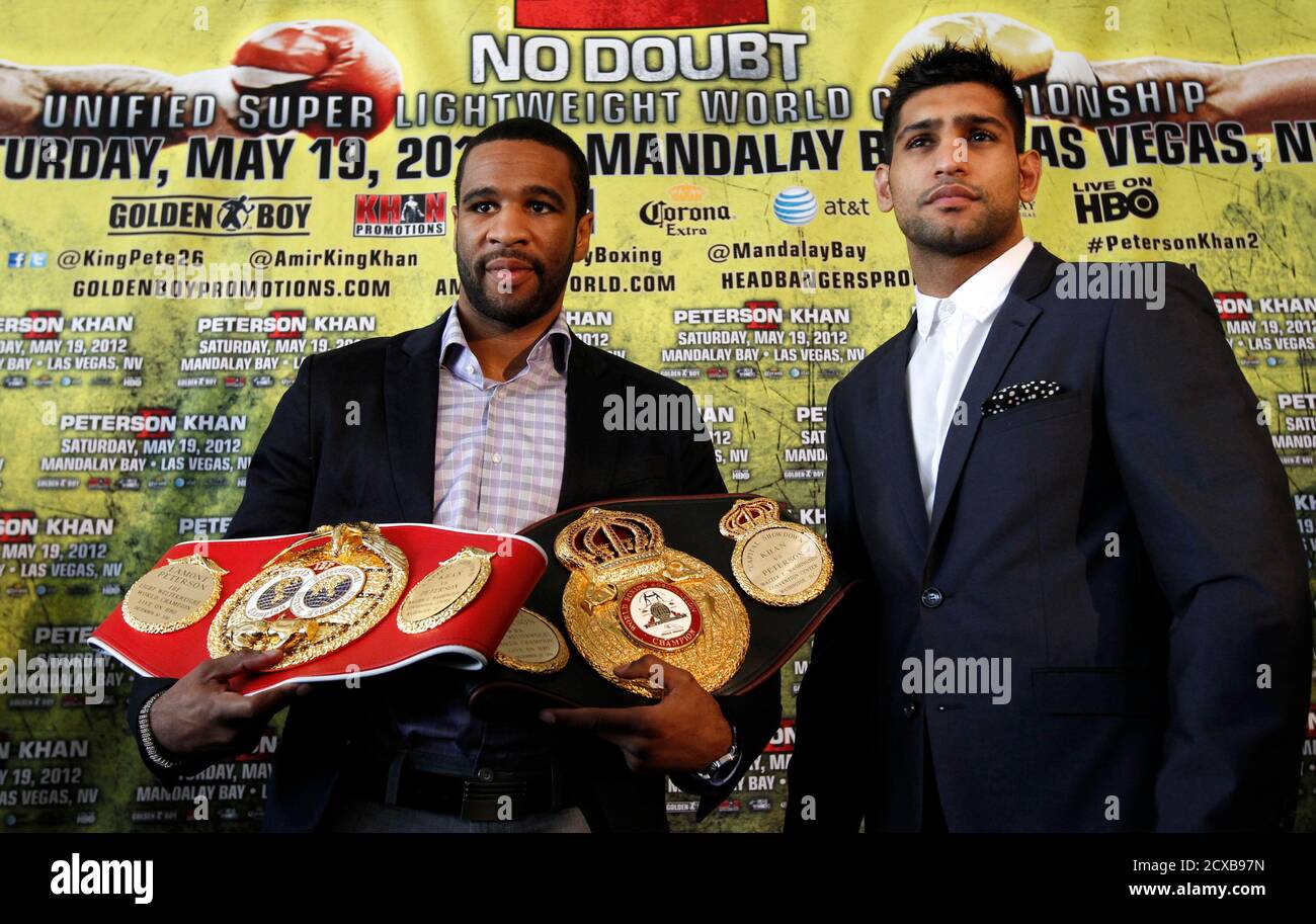 Welterweight boxers Lamont Peterson of the U.S. (L) and Amir Khan of Britain pose during a news conference in Washington March 15, 2012, to announce their rematch in May. Khan lost his IBF and WBA light-welterweight titles after a shock defeat to Peterson in a controversial split decision in Washington last December.   REUTERS/Kevin Lamarque  (UNITED STATES - Tags: SPORT BOXING) Stock Photo