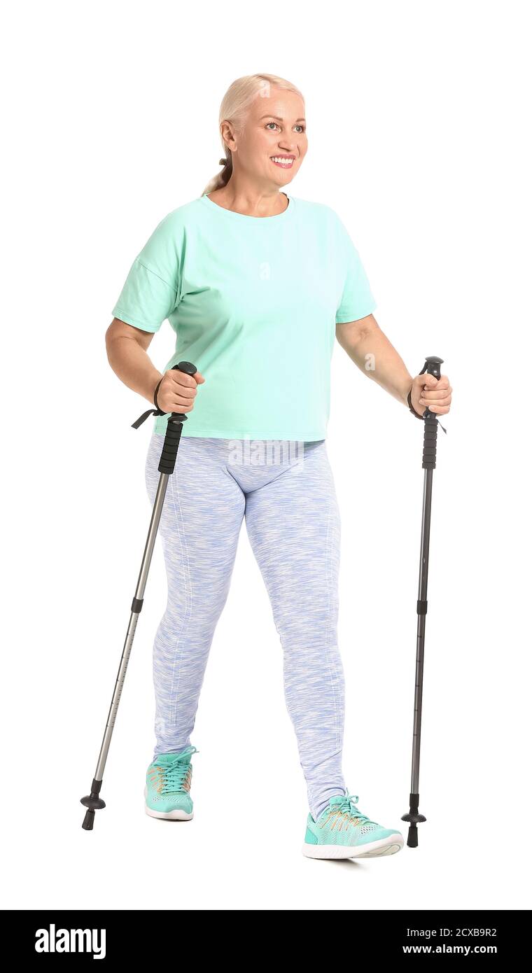 Mature woman with walking poles on white background Stock Photo