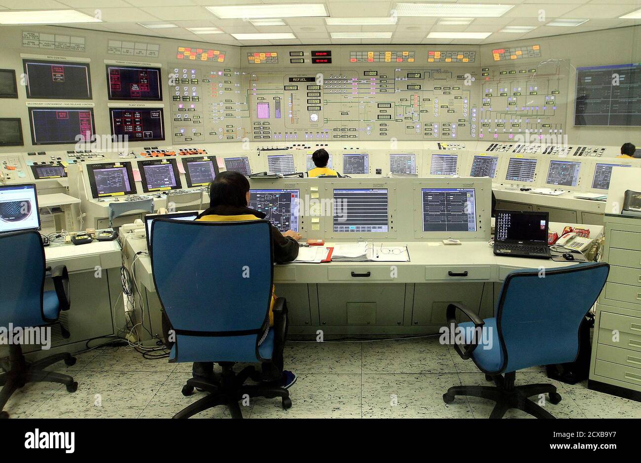 Employees look at readings inside the control room of the first reactor at yet-to-be-completed Taipower Fourth Nuclear Power Plant in Gongliao, New Taipei City, May 14, 2012. The completion date of the Fourth Nuclear Power Plant is repeatedly postponed due to safety concern. Taipower had incorporated improvements to the project, such as an emergency diesel generator facility, after the Fukushima Nuclear Power Plant crisis in Japan, according to local media. REUTERS/Fang Wan-ming/Pool (TAIWAN - Tags: ENERGY) Stock Photo