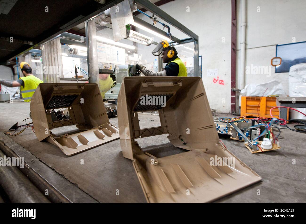 The plastic shell of a French Minitel terminal moves on a conveyor belt as it is broken down for recycling in Portet-Sur-Garonne, southwestern France May 23, 2012. The Minitel, the box-like terminal with a keyboard and monochrome screen, was introduced on the market in 1982 by telecommunications operator France Telecom and used by the French to get information as a phone directory or to purchase train tickets. Although there are between 600,000 - 700,000 of the units still in use, the Minitel service will end on June 30, 2012.   REUTERS/Bruno Martin   (FRANCE - Tags: SCIENCE TECHNOLOGY ENVIRON Stock Photo