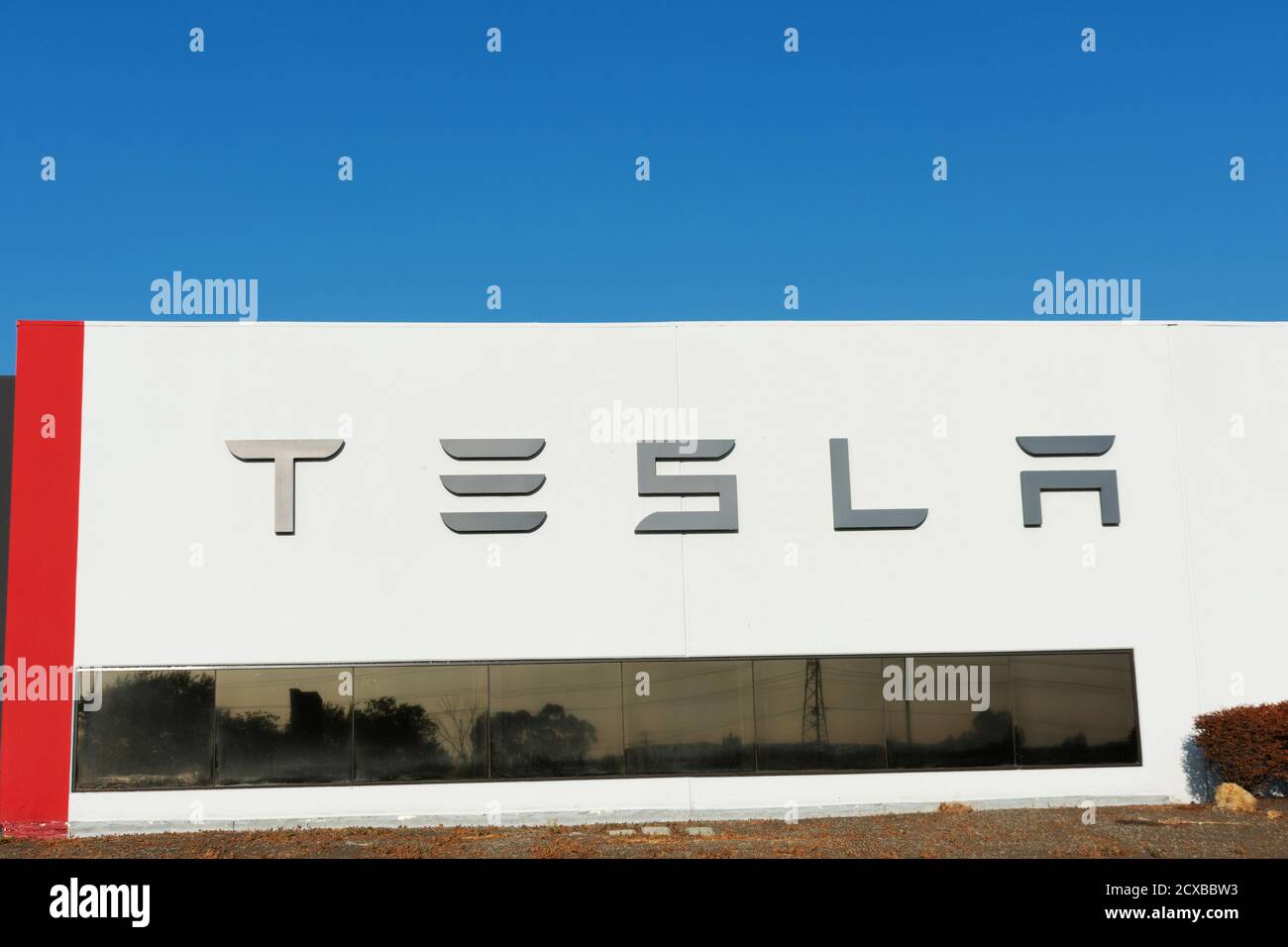 Tesla sign displayed on the exterior wall of Tesla Factory, automobile manufacturing plant in Silicon Valley - Fremont, California, USA - 2020 Stock Photo