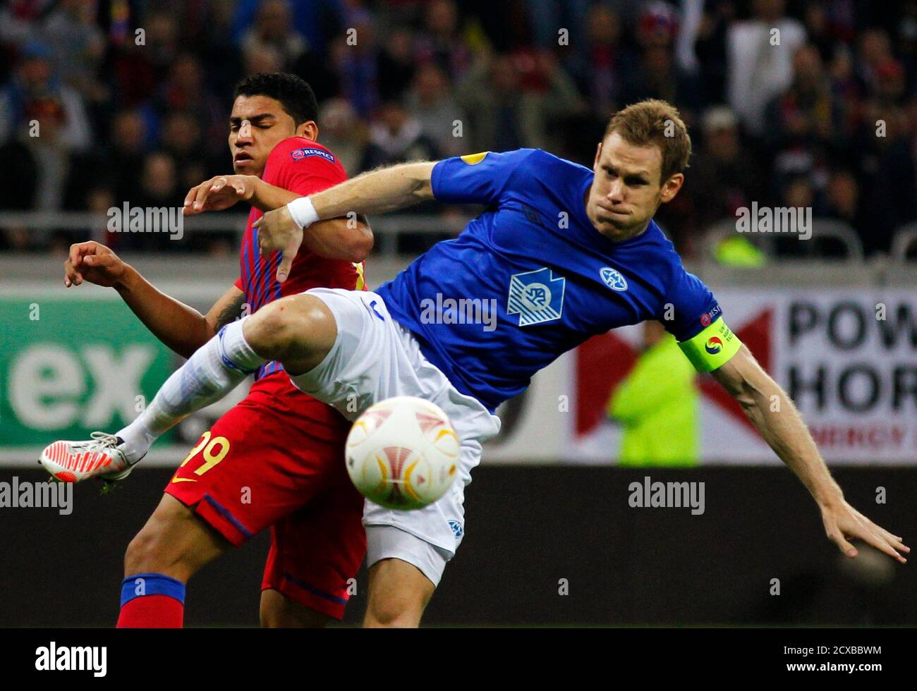 Steaua Bucharest's Adi Sobrinho (L) challenges Molde's Boerre Steenslid  during their Europa League Group E soccer match at National Arena in  Bucharest October 25, 2012. REUTERS/Bogdan Cristel (ROMANIA - Tags: SPORT  SOCCER