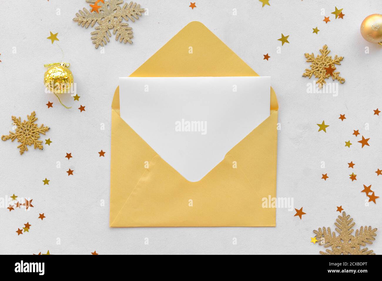 Beautiful Christmas decorations with empty card and envelope on white ...