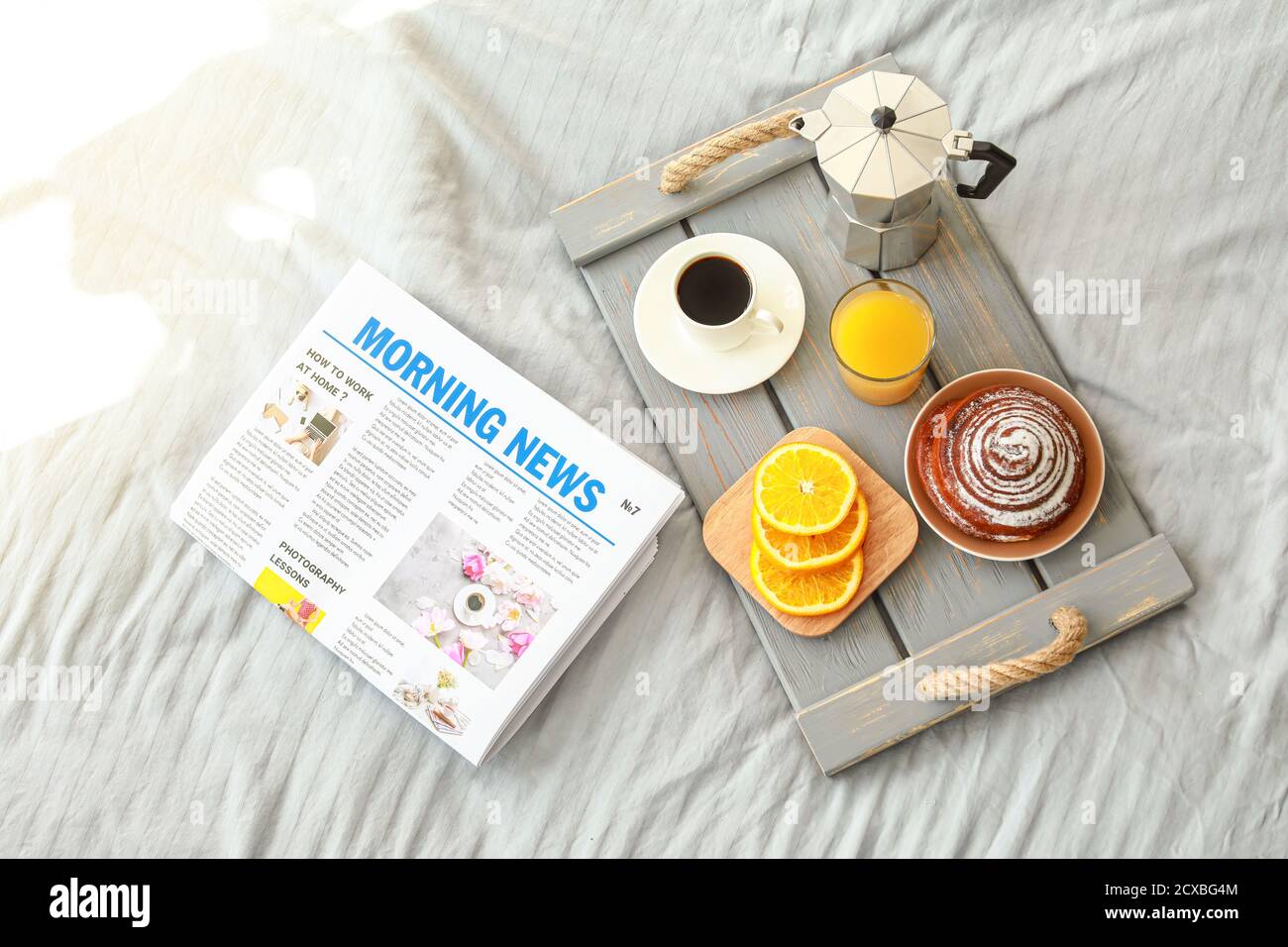 Tray with tasty breakfast and newspaper on bed Stock Photo Alamy
