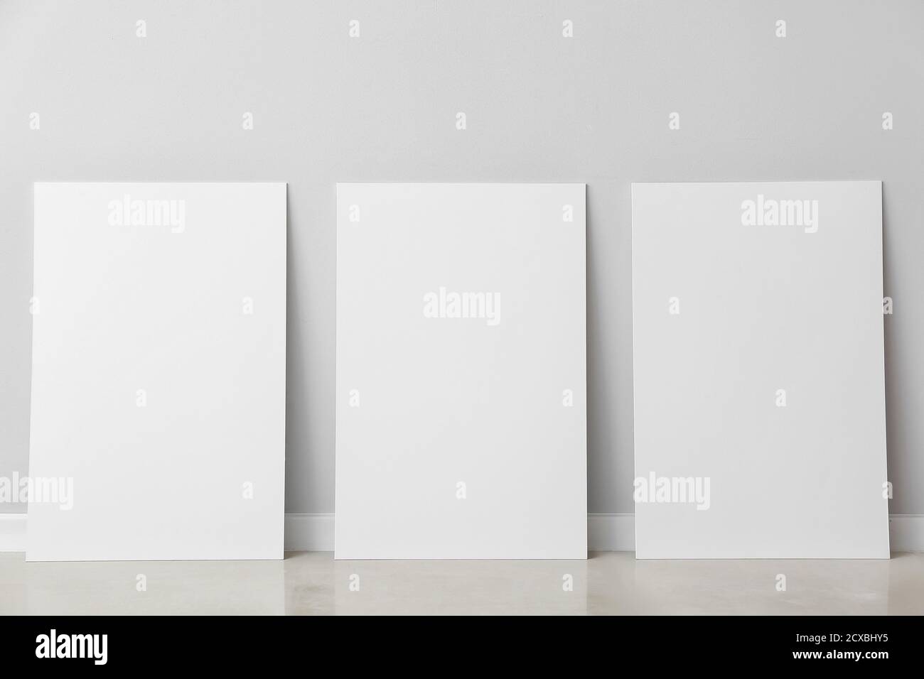 Blank posters near light wall Stock Photo Alamy