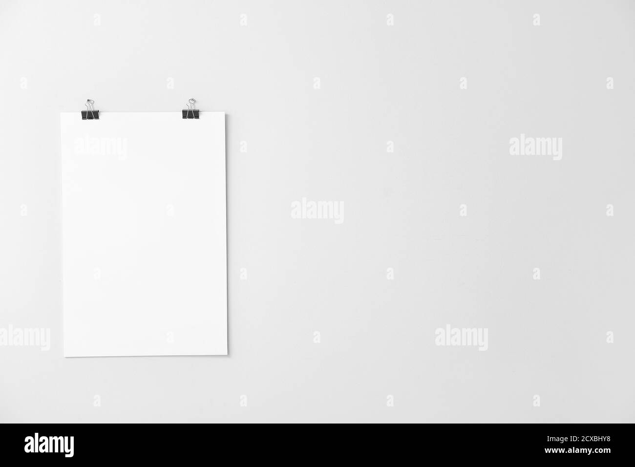 Blank poster hanging on white wall Stock Photo Alamy