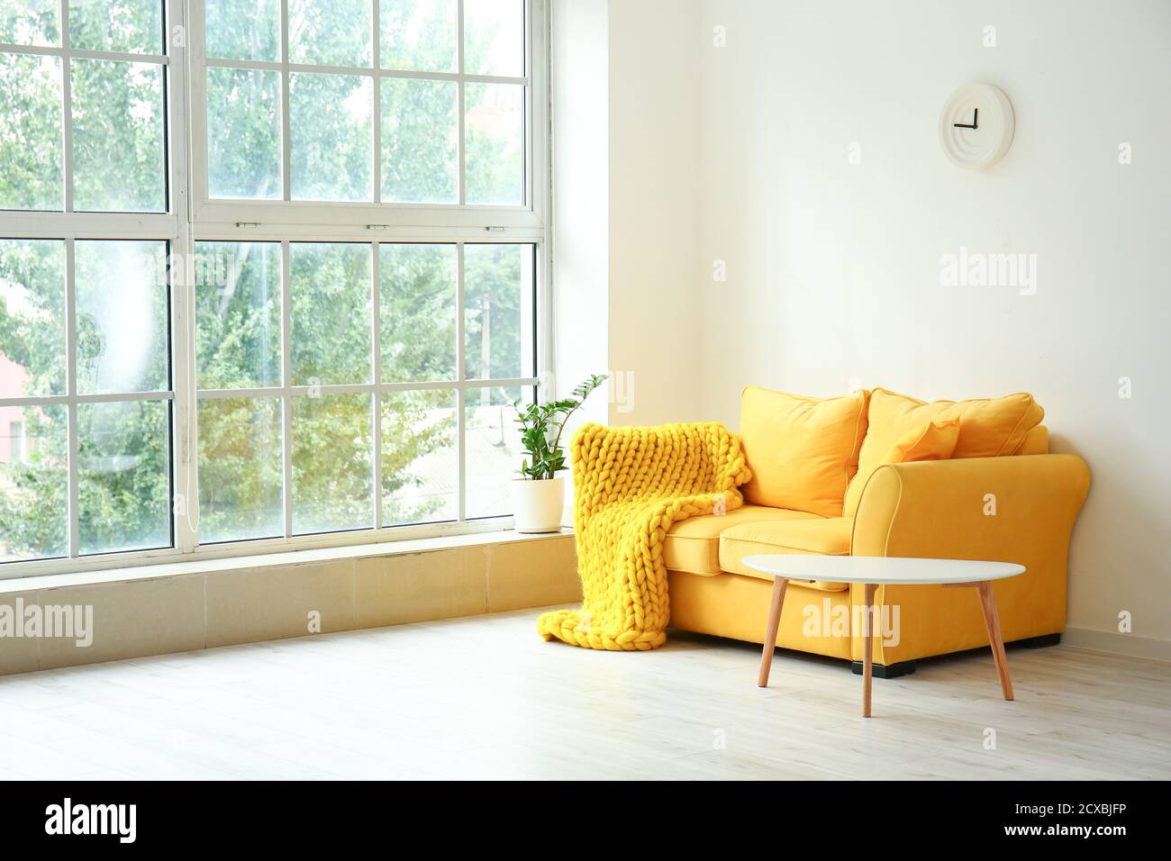 Interior of modern room with sofa near window Stock Photo Alamy