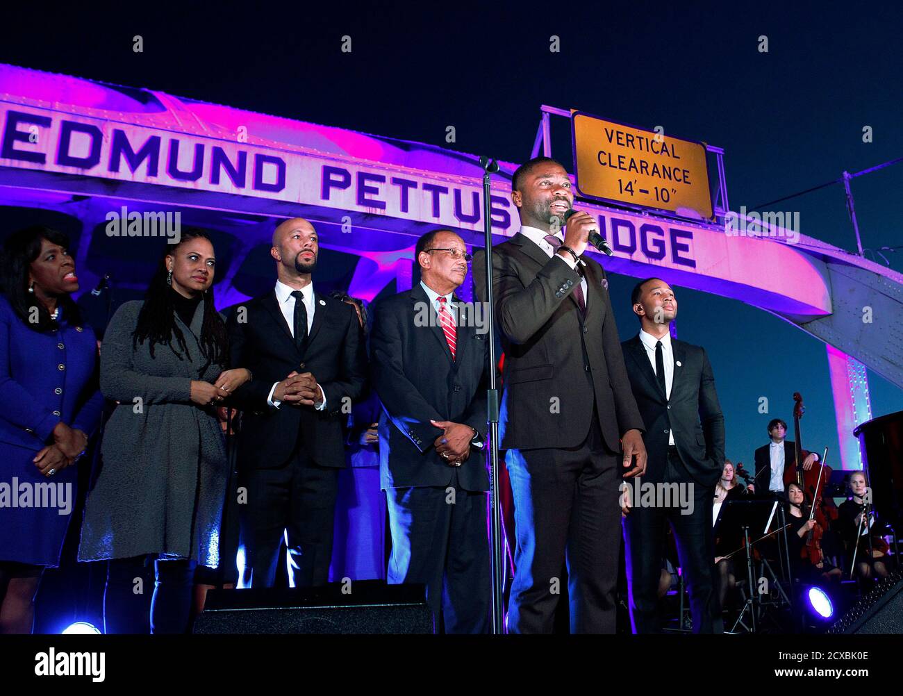 Actor David Oyelowo (front), who portrays Martin Luther King Jr. in the movie 'Selma', speaks at the Edmund Pettus Bridge as (rear L-R) Congresswoman Terri Sewell, director Ava DuVernay, cast member Common, Selma mayor George Evans, and musician John Legend listen in Selma, Alabama January 18, 2015. Stars of the Oscar-nominated movie 'Selma' marched with thousands of people in the Alabama city on Sunday afternoon in honor of Martin Luther King Jr.'s birthday.   REUTERS/Tami Chappell  (UNITED STATES - Tags: ENTERTAINMENT POLITICS ANNIVERSARY) Stock Photo