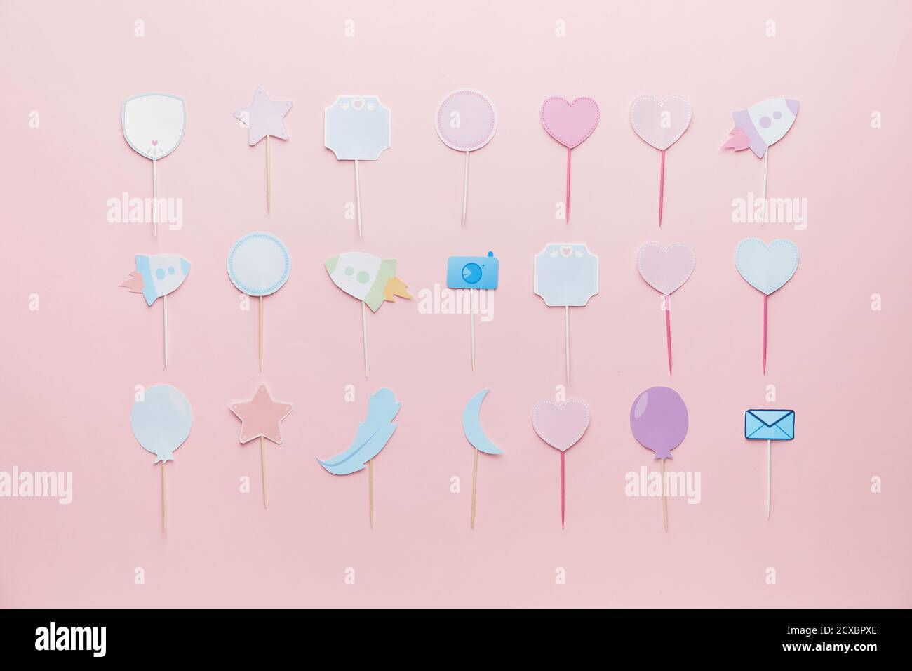 Stylish cupcake toppers on color background Stock Photo - Alamy