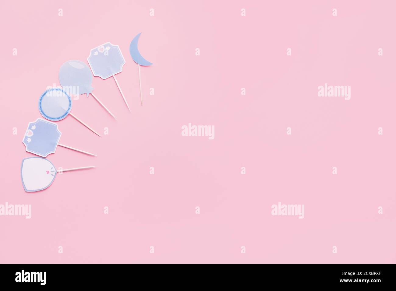 Stylish cupcake toppers on color background Stock Photo - Alamy