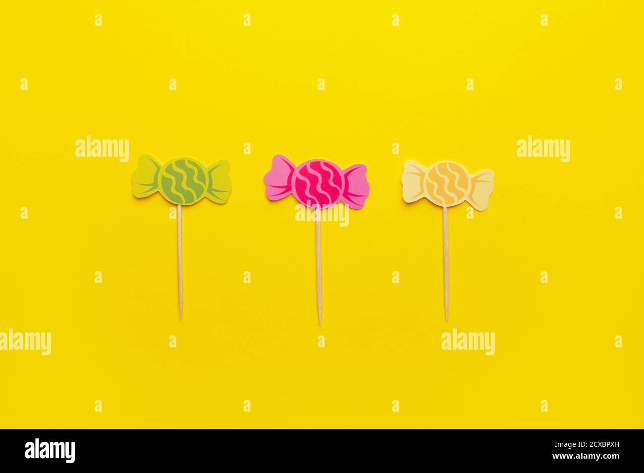 Stylish cupcake toppers on color background Stock Photo - Alamy