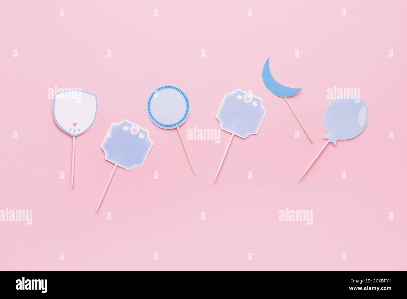 Stylish cupcake toppers on color background Stock Photo - Alamy