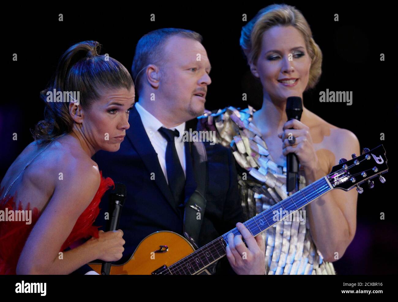 German TV entertainers and hosts of the Eurovision, Judith Rakers (R), Stefan Raab and Anke Engelke (L) perform during the Eurovision Song Contest final in Duesseldorf May 14, 2011.              REUTERS/Wolfgang Rattay (GERMANY  - Tags: ENTERTAINMENT) Stock Photo