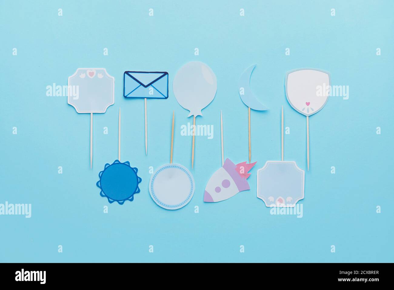 Stylish cupcake toppers on color background Stock Photo - Alamy