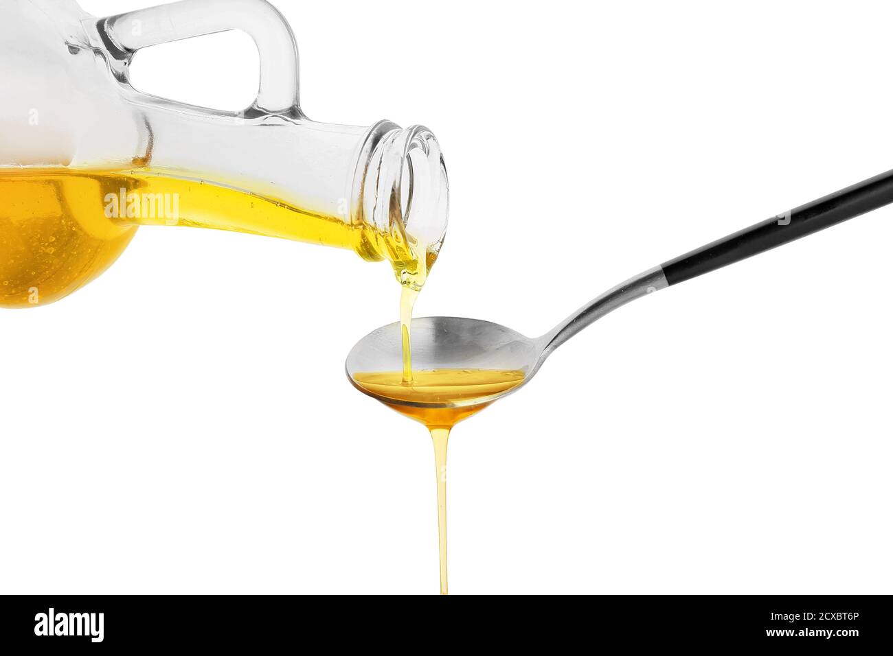 Pouring of fresh olive oil from bottle into spoon on white background ...
