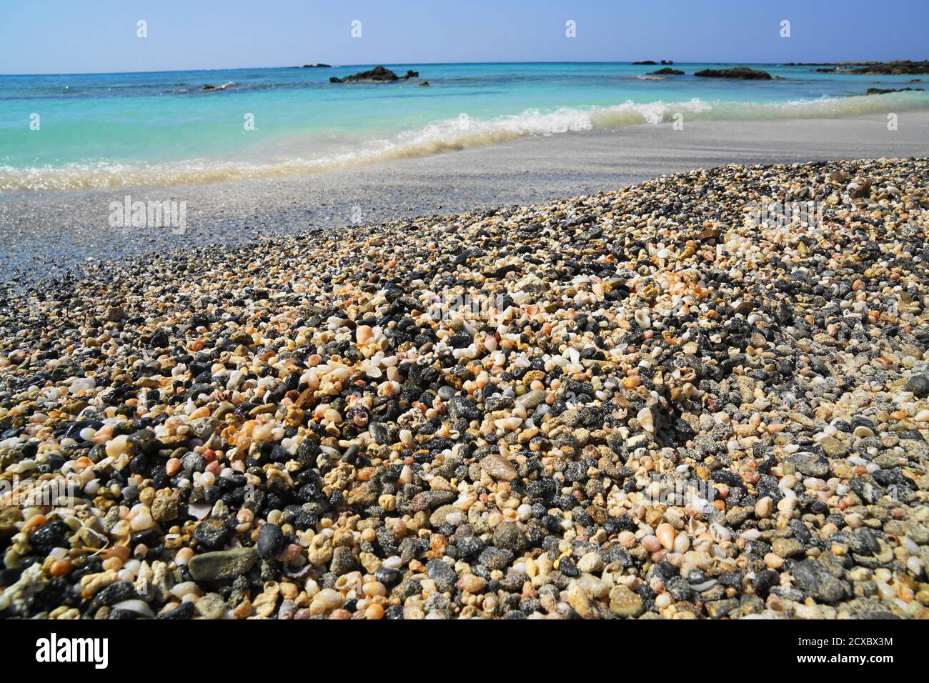 Beach made up of millions of tiny seashells and black rocks in Crete ...