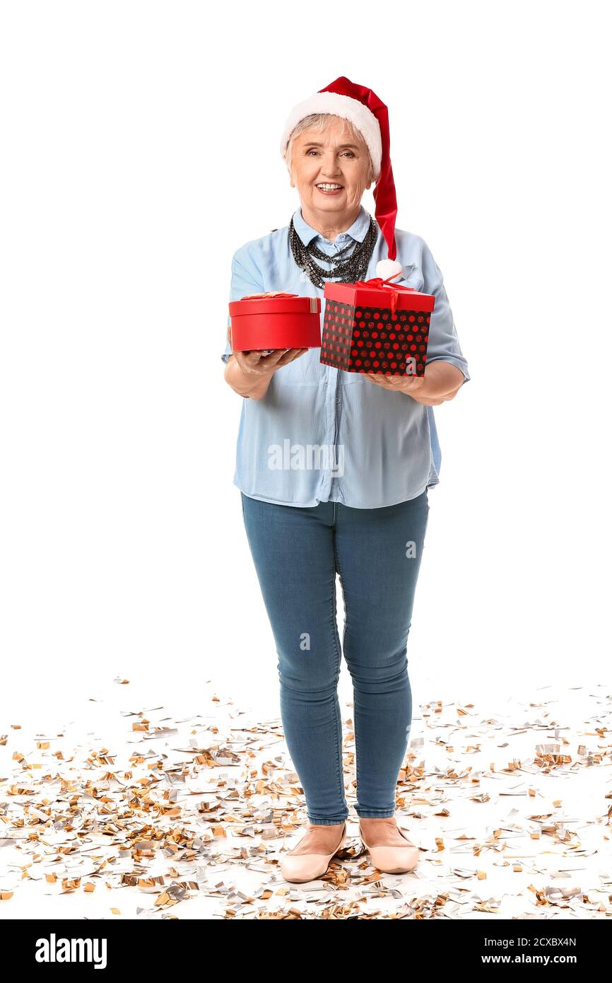 Elderly woman with Christmas gifts on white background Stock Photo - Alamy