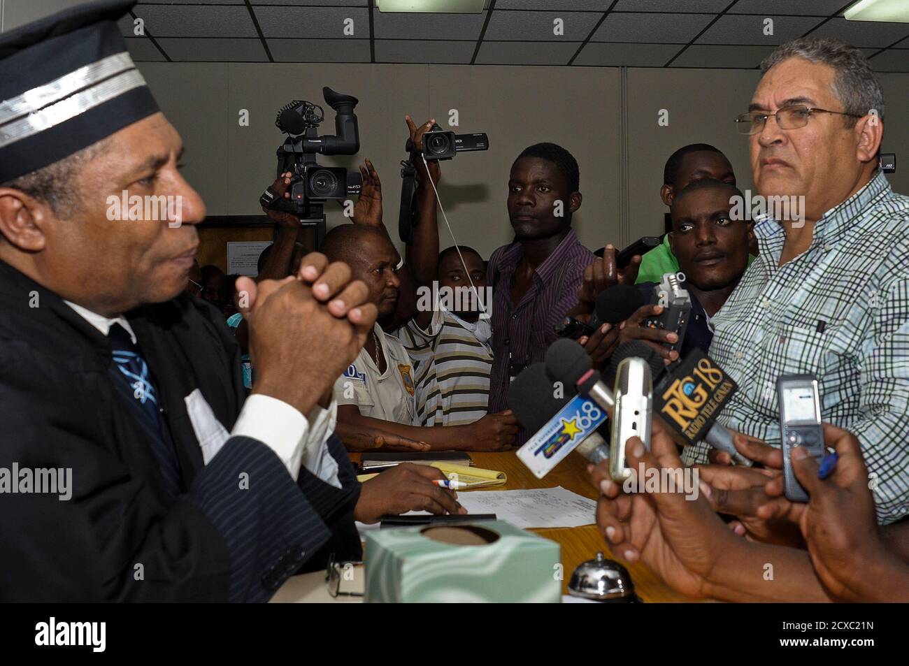 Bob Duval (R), a former political prisoner during Jean-Claude "Baby Doc"  Duvalier's regime, apologises to a judge and the court for his outburst  during the ex-dictator's hearing in Port-au-Prince February 7, 2013.