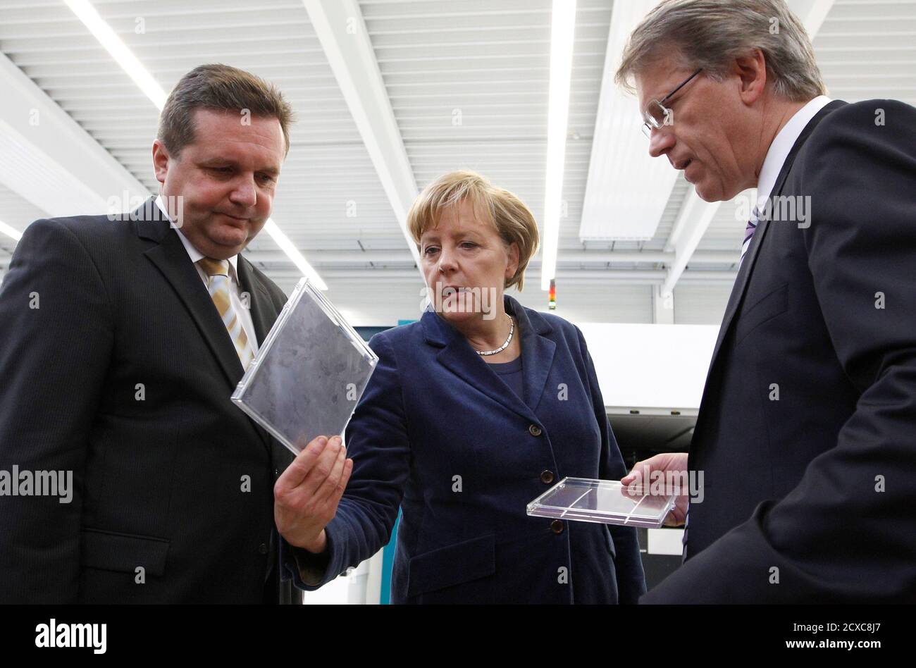 German Chancellor Angela Merkel C Baden Wuerttemberg Premier Stefan Mappus L And Dieter Manz R Ceo