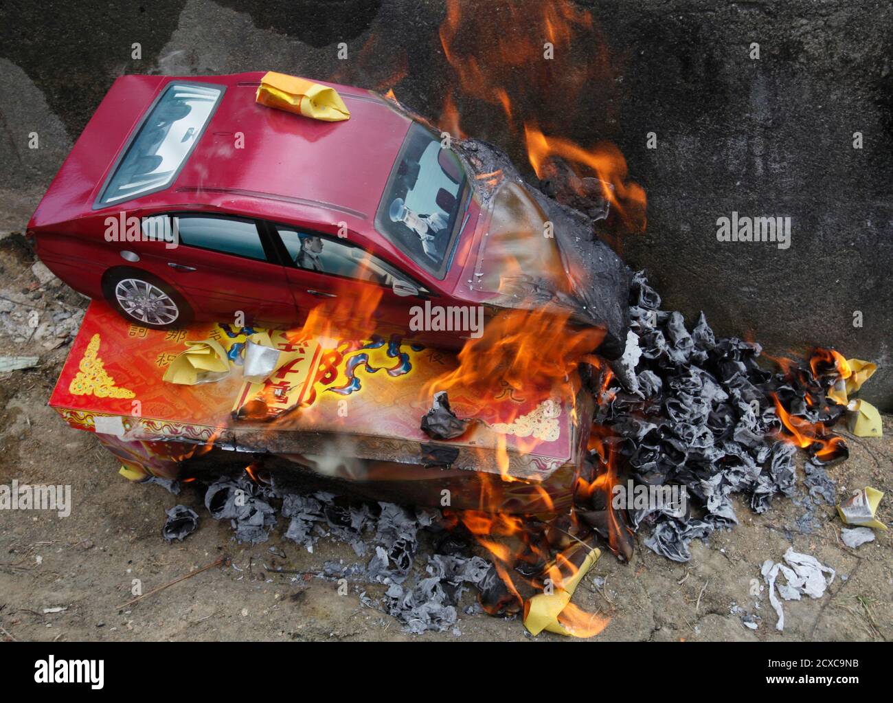 A Paper Replica Of Mercedes Benz Is Burnt As An Offering To The Dead During Chinese Qingming Festival Or Ancestors Day At A Cemetery In Petaling Jaya Outside Kuala Lumpur April 3 2011