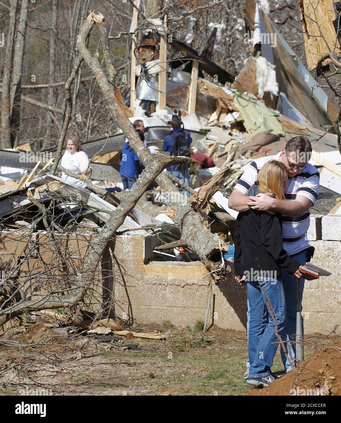 Gary Cross comforts his sister Charlotte Evans in front of the remains of the house where their sister Melissa Evans died near Crossville, Tennessee March 1, 2012.  Evans died in the violent weather that hit six Midwest states starting in Kansas and Missouri overnight and swept into middle Tennessee and slammed the Cumberland Plateau region, about an hour east of Nashville, killing two women in Cumberland County and one person in DeKalb County, according to emergency agency officials.    REUTERS/Harrison McClary (UNITED STATES - Tags: ENVIRONMENT DISASTER) Stock Photo