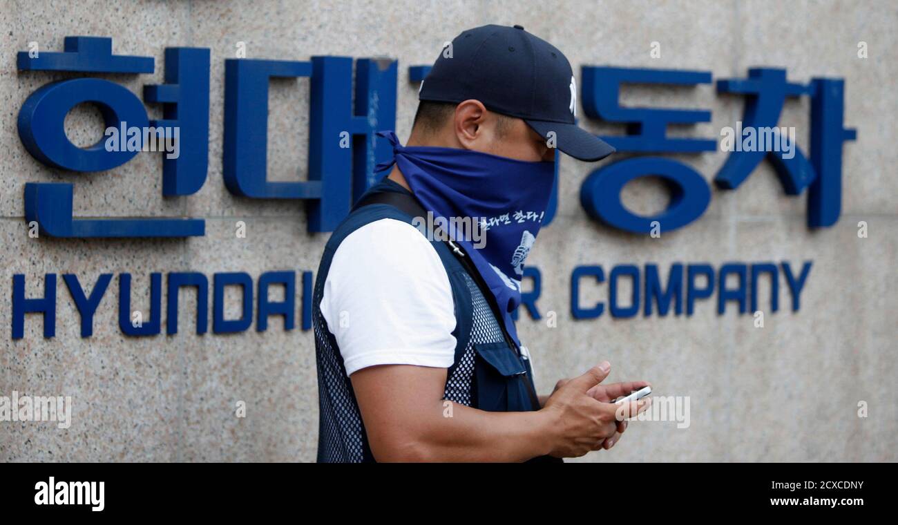 A Hyundai Motor Union Worker Stands In Front Of A Wall With The Company S Logo During A Strike At The Automakers Factory In Asan South Of Seoul July 12 Hyundai Motor A Hyundai Motor Union Worker Stands In Front Of A Wall With The Company S Logo During A Strike At The Automakers Factory In Asan South Of Seoul July 12 Hyundai Motor