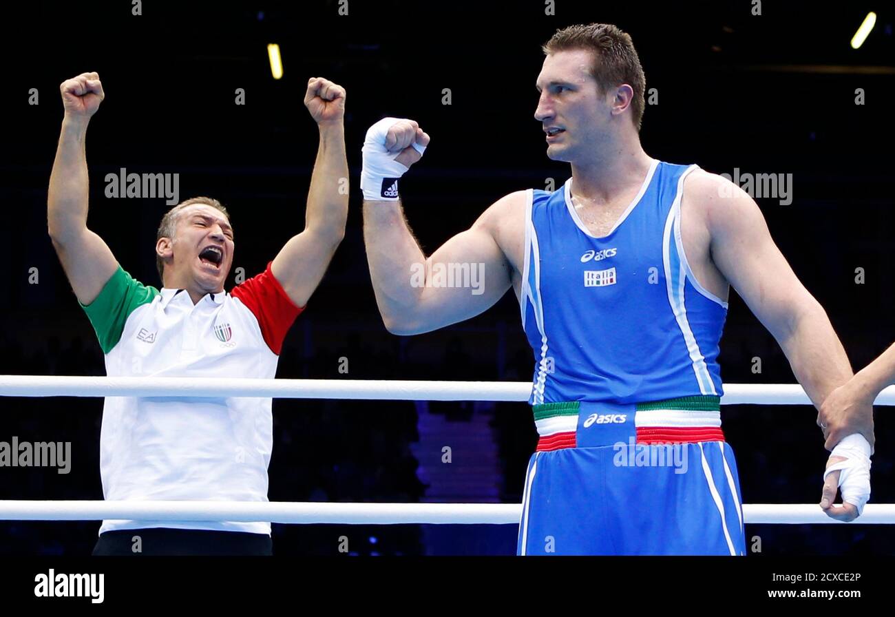 A trainer celebrates as Italy's Roberto Cammarelle is declared the winner  over Azerbaijan's Magomedrasul Medzhidov (not shown) after their Men's  Super Heavy (+91kg) semi-final boxing match at the London Olympic Games  August
