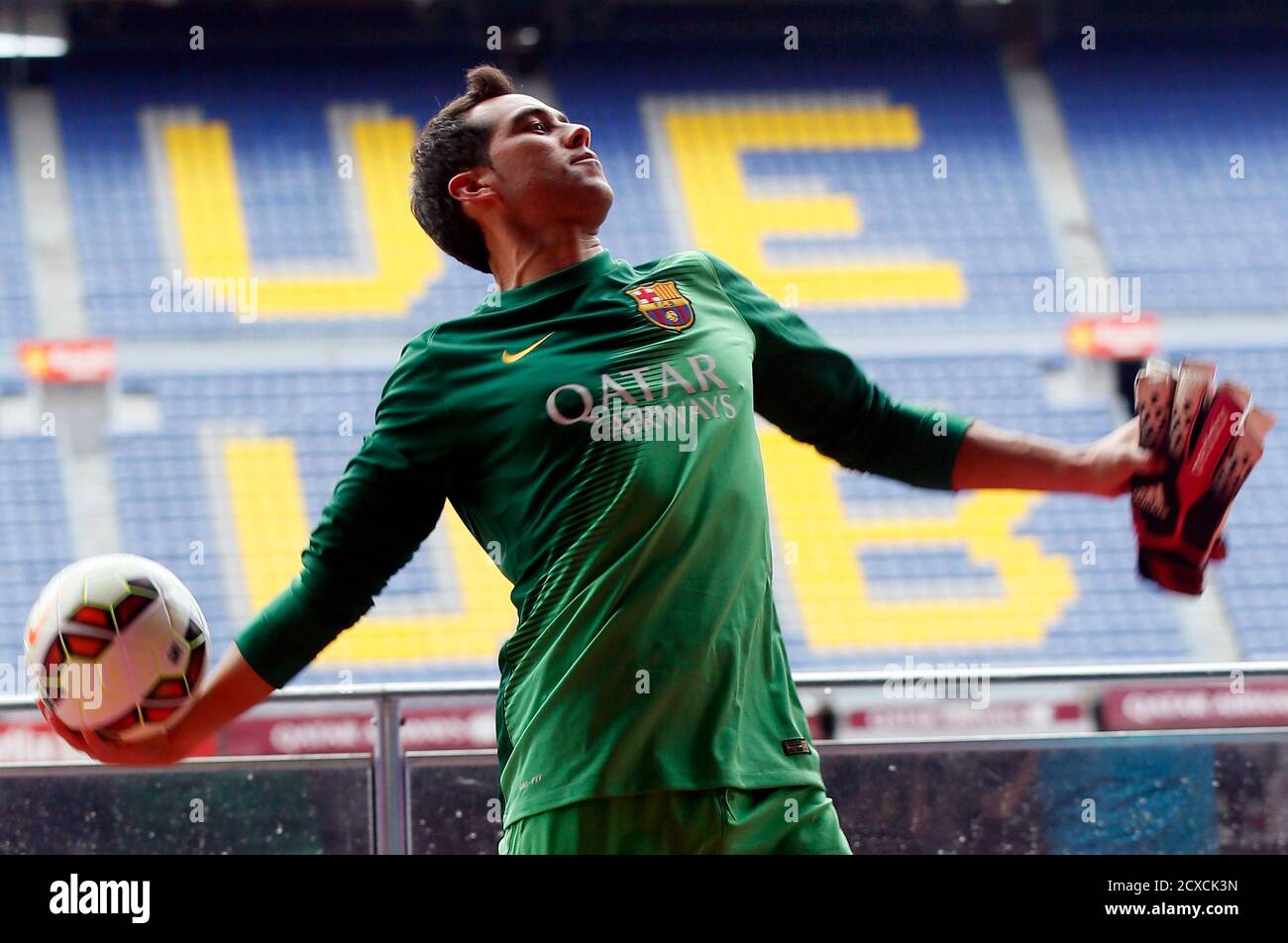 FC Barcelona's newly signed goalkeeper Claudio Bravo from Chile throws a  ball to supporters while wearing his new jersey during his presentation at  Camp Nou stadium, in Barcelona July 7, 2014. REUTERS/Albert