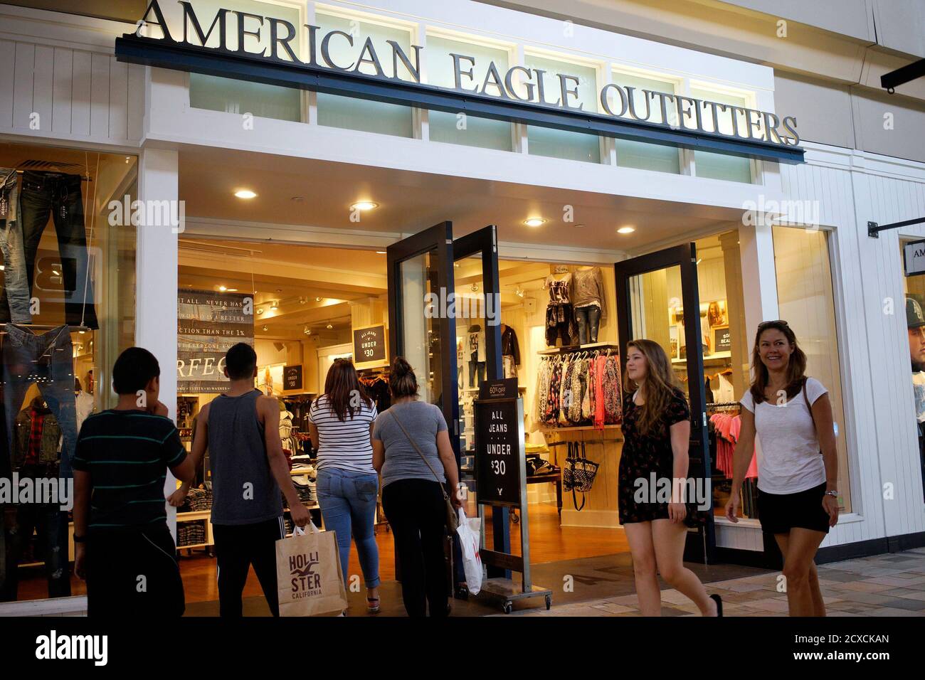 Shoppers enter the American Eagle Outfitters store in Broomfield, Colorado August 20, 2014. American Eagle Outfitters was a bright spot in the retail sector Wednesday after the teen-oriented chain's second-quarter results beat expectations and forecasts for third-quarter earnings were in line with the current estimate. Its stock jumped 12 percent to $12.98.  REUTERS/Rick Wilking (UNITED STATES - Tags: BUSINESS) Stock Photo