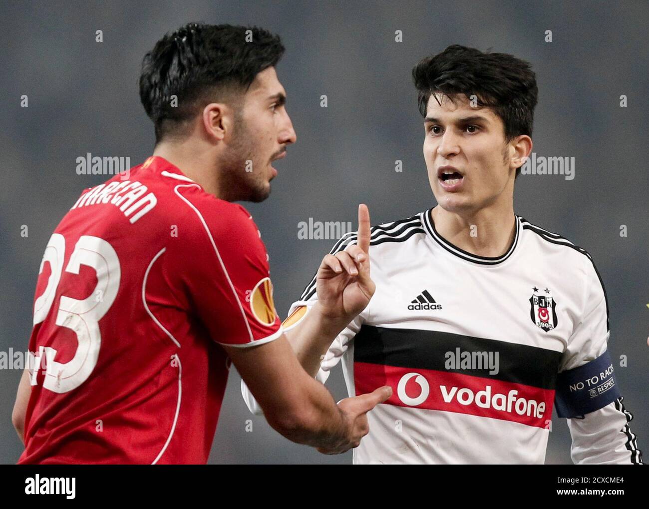 Necip Uysal (R) of Besiktas gestures to Emre Can of Liverpool during their  Europa League round of 32 second leg soccer match against Besiktas in  Istanbul February 26, 2015. REUTERS/Osman Orsal (TURKEY -