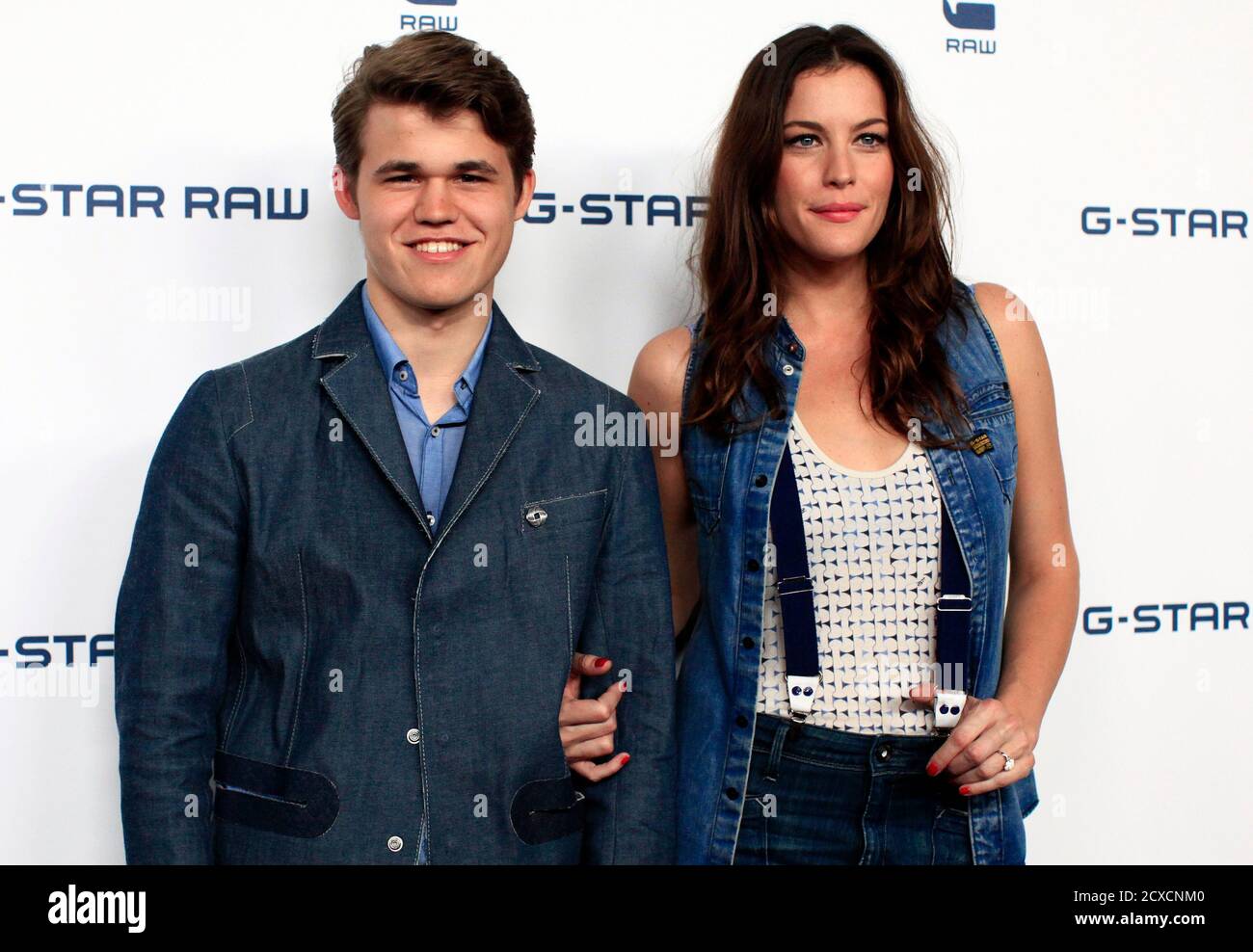 Norwegian chess champion Magnus Carlsen enters the red carpet with actress Liv  Tyler as front row special guests at the G-Star RAW Spring/Summer 2011  collection during New York Fashion Week, September 14,