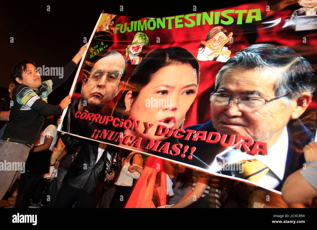 A Man Holds A Sign With The Faces Of Former Spy Chief Vladimiro Montesinos L Peru S Presidential Candidate Keiko Fujimori And Former Peru S President Alberto Fujimori During A Protest In Lima May
