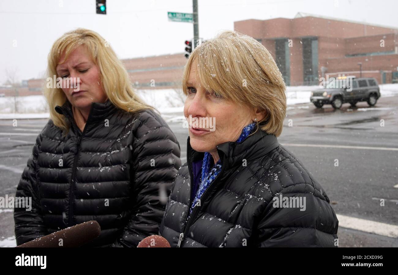 Cheri Spottke (L), an investigator with the Westminster Police Department, listens as Lynn Setzer, public information officer for Jefferson County schools, talk to the media outside Standley Lake High School in Westminster January 27, 2014.  A 16-year-old student set himself on fire in the cafeteria of the suburban Denver high school on Monday in what police said was an apparent suicide attempt and they evacuated the campus. The student at Standley Lake High School in the suburb of Westminster suffered burns over 80 percent of his body, according to a spokeswoman for the town's fire department Stock Photo