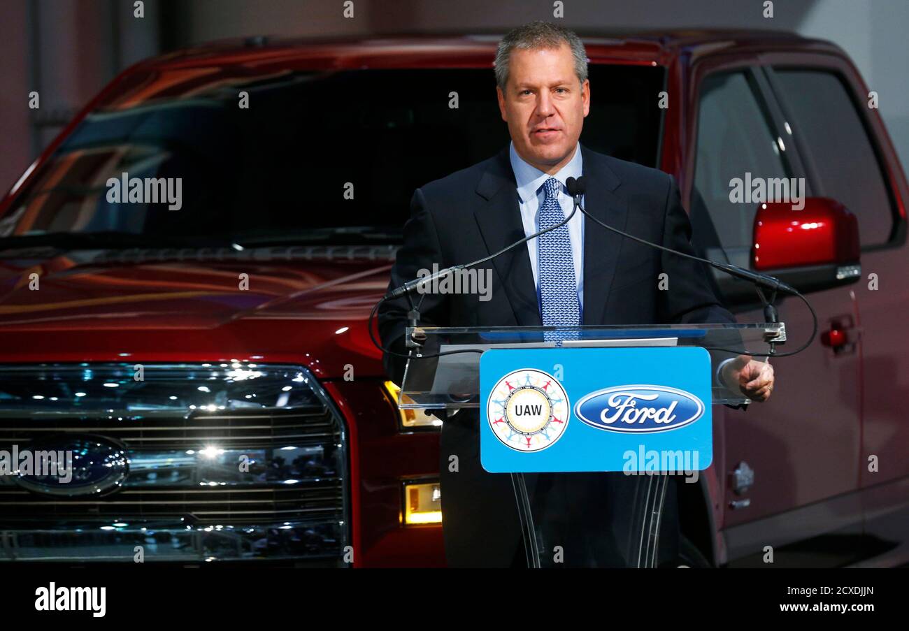 Ford Motor president of the Americas Joseph Hinrichs stands in front of an all new 2015 F-150 pick-up truck during a news conference at the Rouge Plant in Dearborn, Michigan October 13, 2014. Ford Motor Co said on Monday it will add 850 hourly jobs at its Dearborn, Michigan, facilities to support the launch of the redesigned, aluminum-intensive 2015 F-150 pickup truck. The No. 2 U.S. automaker said the new jobs are divided among three facilities: more than 500 jobs for the truck assembly plant, nearly 300 for the stamping factory and more than 50 at the diversified operations.REUTERS/Rebecca C Stock Photo