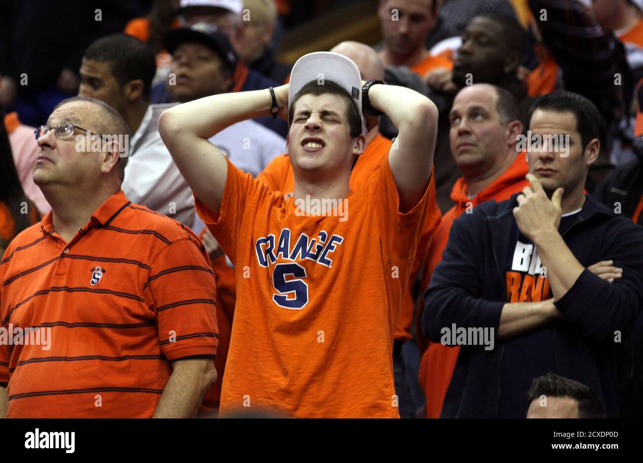 Syracuse fans react as the Orangemen are defeated by Marquette University during their third round NCAA basketball game in Cleveland March 20, 2011.REUTERS/Aaron Josefczyk (UNITED STATES - Tags: SPORT BASKETBALL) Stock Photo