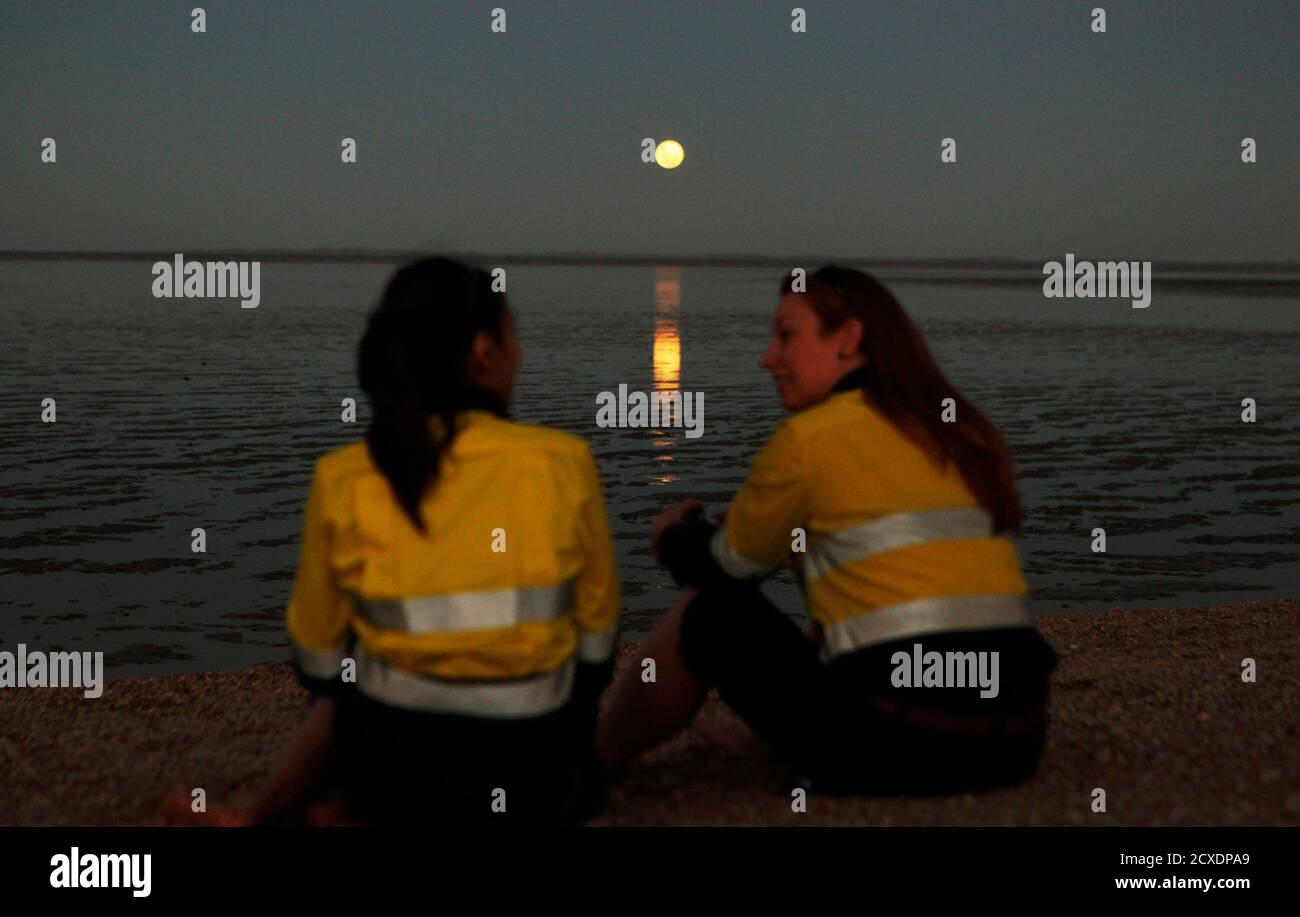 Two Workers Chat As The Full Moon Is Reflected On The Low Tide At Hearson S Cove
