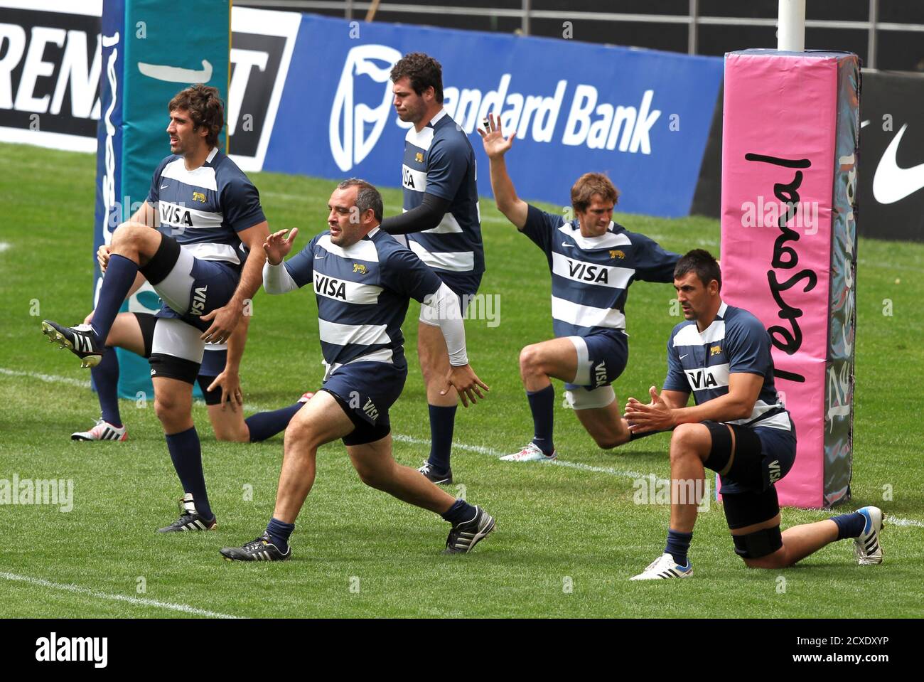 Players of Argentina's Los Pumas rugby team warm up before a practice  session at the Estadio Unico in La Plata September 28, 2012. Argentina's  Los Pumas will clash with New Zealand's All