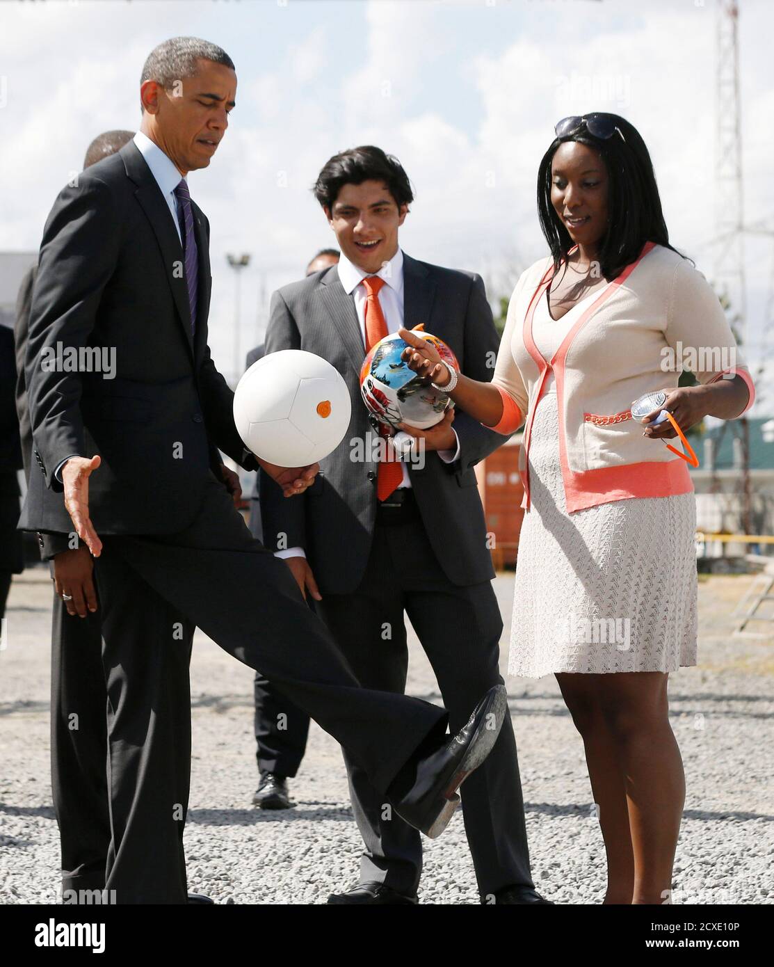 U S President Barack Obama L Kicks A Soccer Ball At Ubungo Power Plant In Dar Es Salaam July 2 2013 The Ball Called A Soccket Ball Has Internal Electronics That Allows It