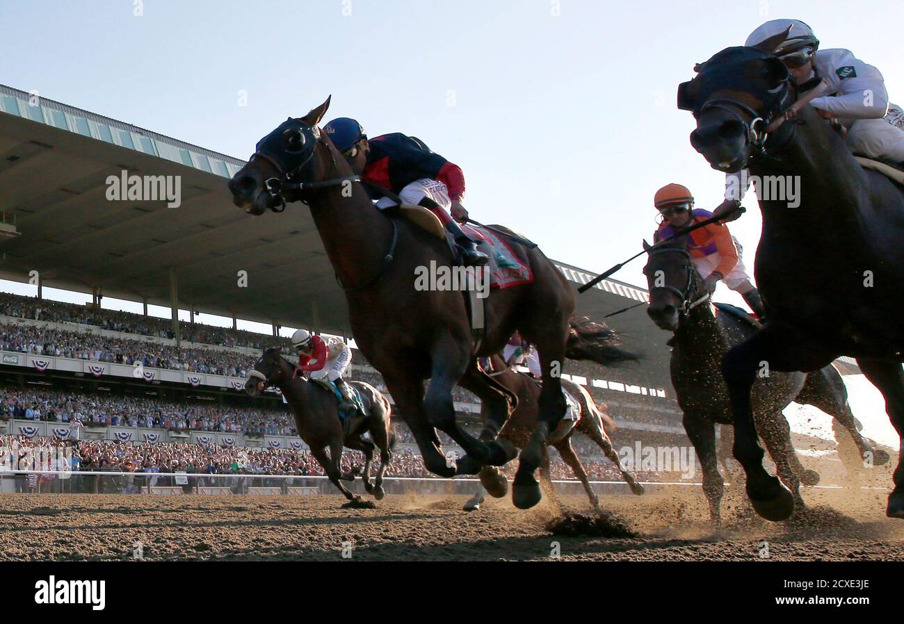 Tonalist (C) with jockey Joel Rosario races to win the 146th running of the Belmont Stakes at Belmont Park in Elmont, New York, June 7, 2014. Commissioner who placed second is at right. Kentucky Derby and Preakness winner California Chrome who finished fourth is at back center (obscured) and Wicked Strong with Jockey Rajiv Maragh is at left . REUTERS/Mike Segar    (UNITED STATES - Tags: SPORT HORSE RACING TPX IMAGES OF THE DAY) FOR BEST QUALITY IMAGE SEE GF2EA9F1F5S01 Stock Photo