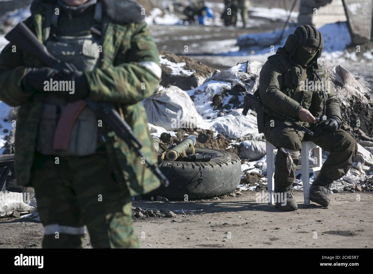A fighter with the separatist self-proclaimed Donetsk People's Republic Army sits at a checkpoint along a road from the town of Vuhlehirsk to Debaltseve in Ukraine, in this picture taken February 18, 2015. To match Special Report UKRAINE-CRISIS/SOLDIERS   REUTERS/Baz Ratner Stock Photo