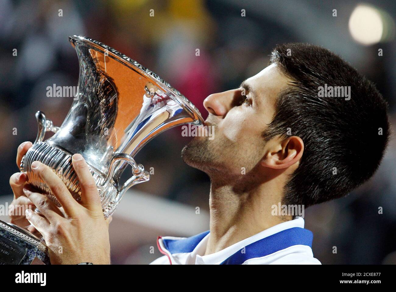 Novak Djokovic of Serbia kisses the trophy after winning against Rafael  Nadal of Spain their final