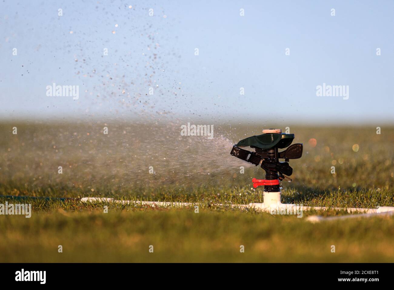 Up close photo of an automatic impact water sprinkler mounted on a