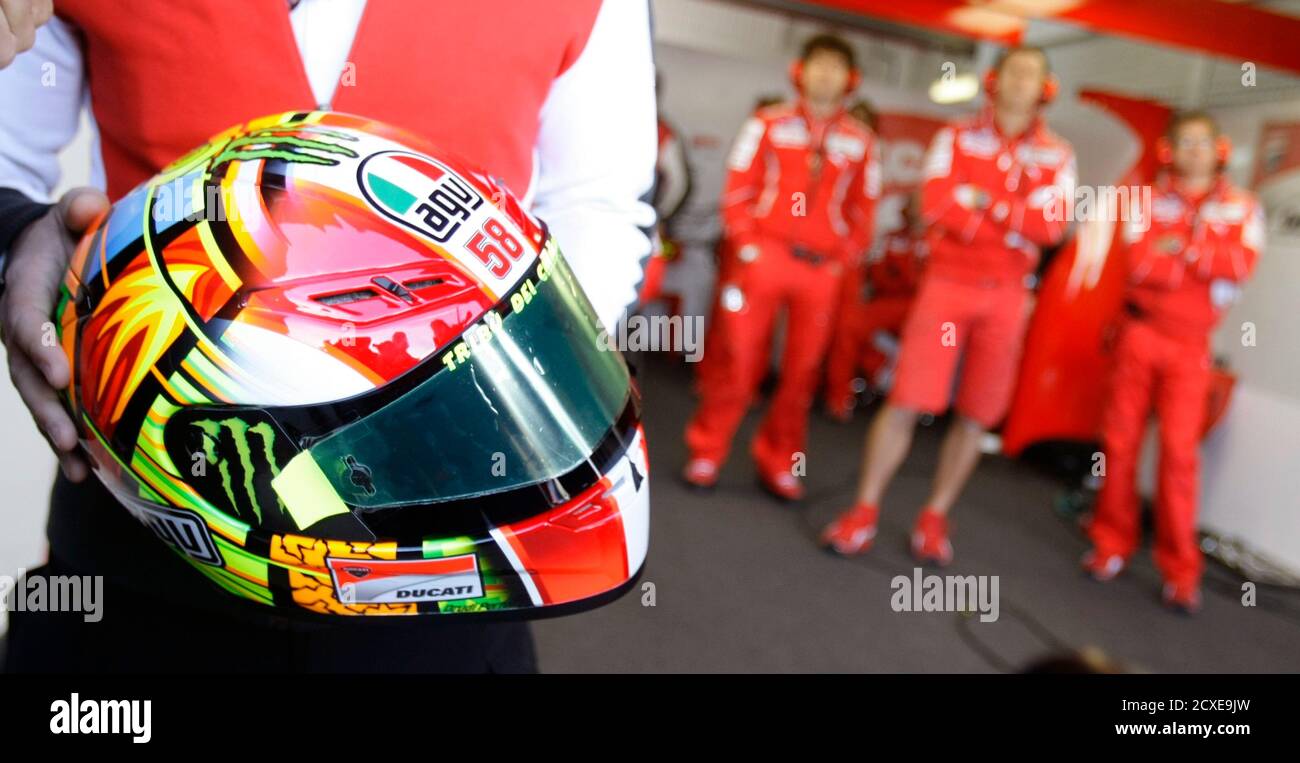 A mechanic holds Ducati MotoGP rider 
