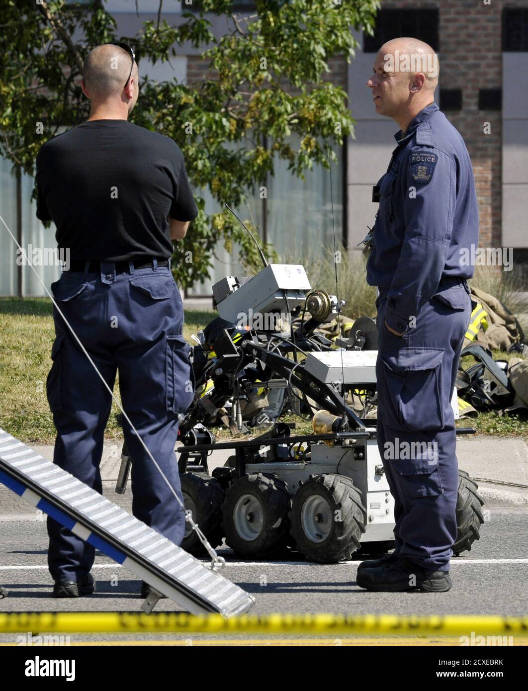 Peel Regional Police Officers deploy a robot to investigate a suspicious death, originally rumoured to be a bomb threat, at a motel in Mississauga, Ontario July 11, 2012.  REUTERS/J.P. Moczulski  (CANADA - Tags: SOCIETY CRIME LAW) Stock Photo